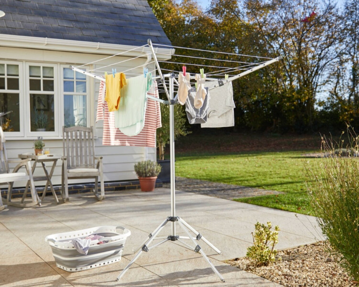 Freshly washed clothes drying on a rotary washing line in a sunny garden